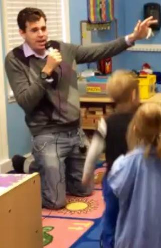 Joe performs for the children.